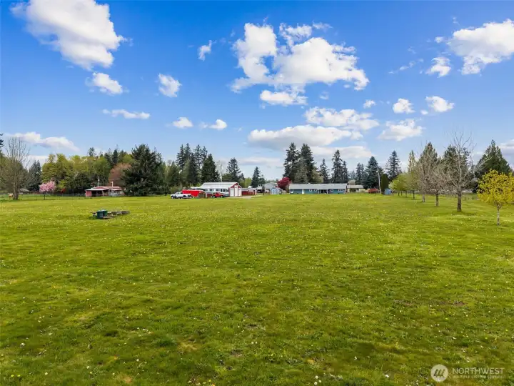 From the back of the property looking toward the home and outbuildings, you can really appreciate the scale of these 4.81 acres and how much usable ground remains. There is room here not just to enjoy what already exists, but potentially to think bigger. Buyers may wish to verify with the appropriate county authorities the potential for an additional dwelling unit, but there appears to be ample space for exploring that possibility. And that is where this starts taking on estate-style energy. Main home, outbuildings, pasture, and perhaps future guest quarters or multigenerational living, all layered into one property, your own mini-estate!