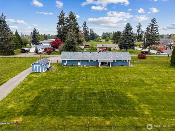 From the back fence looking across the property, you can see the darker green area marking the septic drainfield near the home, thoughtfully positioned where it works well with the existing outbuildings and daily use of the land. And it becomes a natural moment to talk about what has happened here since 2021, because it is significant. Over $200,000 in improvements, including the major kitchen remodel, electrical upgrades, newer roof, newer heat pump and A/C, updated well components, barn improvements, driveway work, fencing, and more. That kind of investment changes how a property feels. You are not stepping into a long deferred-maintenance project. You are stepping into a place where much of the hard, expensive work has already been handled, leaving more room to simply enjoy the land and start living.