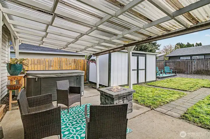 Covered porch with a gas firepit.