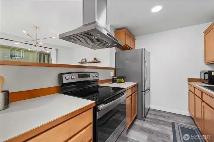 Kitchen with stainless steel venthood and electric range