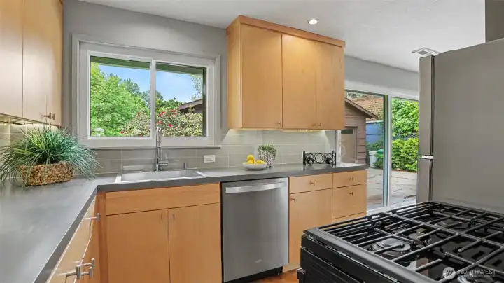 This remodeled kitchen boasts gorgeous custom maple cabinetry with under-cabinet lighting. This remodeled kitchen boasts gorgeous custom maple cabinetry with under-cabinet lighting.