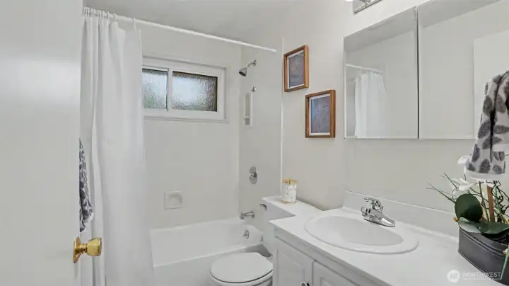 This full bathroom includes a refinished tub-shower combo, built-in linen closet, and under-sink storage. This full bathroom includes a refinished tub-shower combo, built-in linen closet, and under-sink storage.