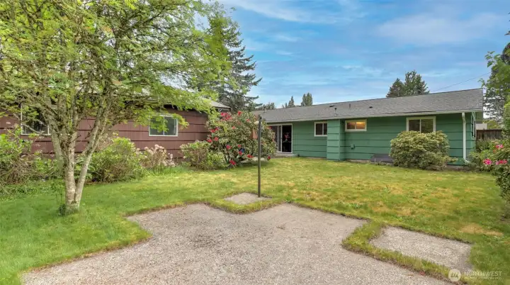 The lush green grounds are accented by beautiful, mature landscaping with pops of pink and red flowers. The lush green grounds are accented by beautiful, mature landscaping with pops of pink and red flowers.