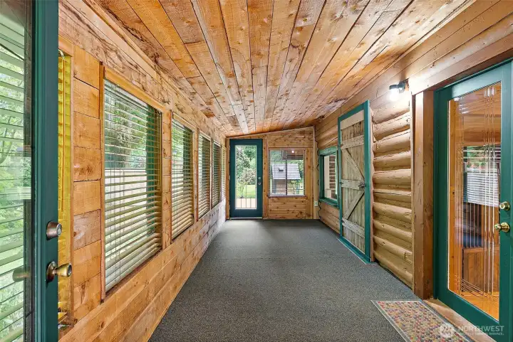 Enclosed front porch, the far door opens to the backyard. Such a relaxing space. Enclosed front porch, the far door opens to the backyard. Such a relaxing space.