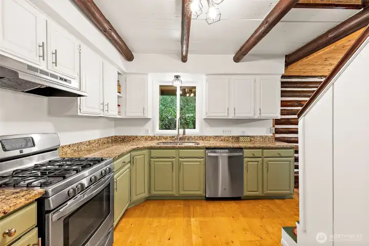 Closer view into kitchen. Stairway on the right leads to the bedrooms and flex space upstairs. The stairway contains an added unique surprise. Closer view into kitchen. Stairway on the right leads to the bedrooms and flex space upstairs. The stairway contains an added unique surprise.