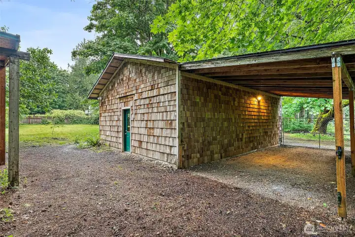Back of detached garage with covered parking for your toys. Back of detached garage with covered parking for your toys.