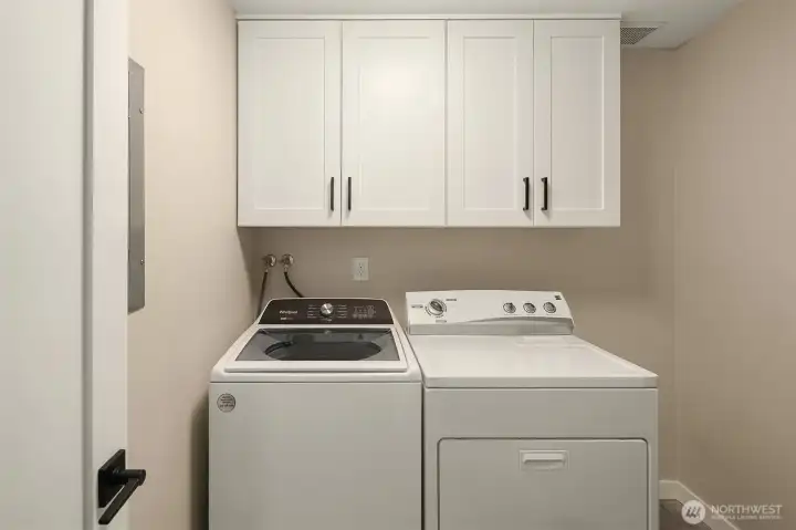 Nice sized laundry room with plenty of storage