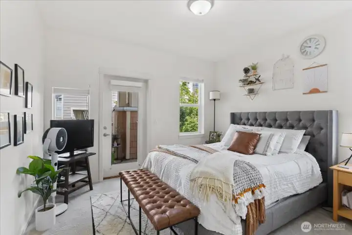 Spacious primary bedroom with access to the balcony.