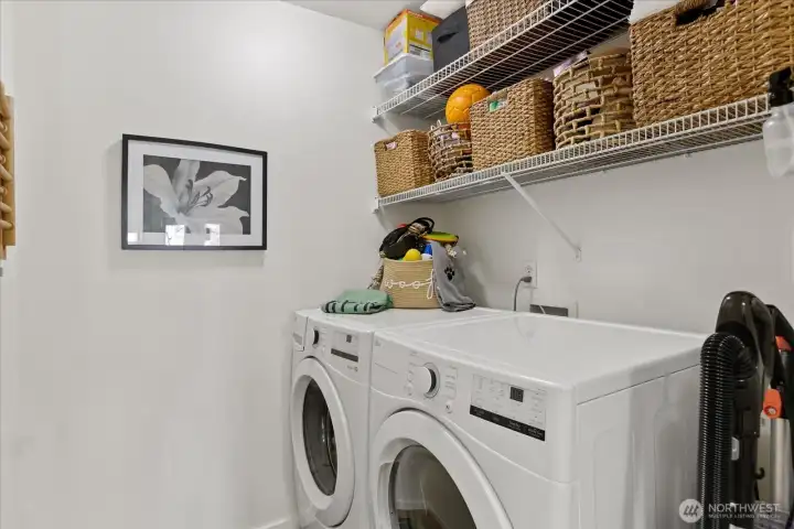 Laundry room with storage shelves.
