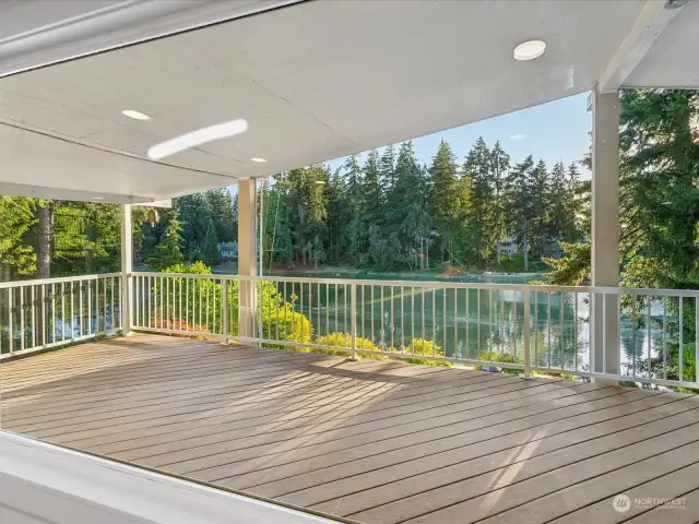 View from living room to large covered deck and the bay