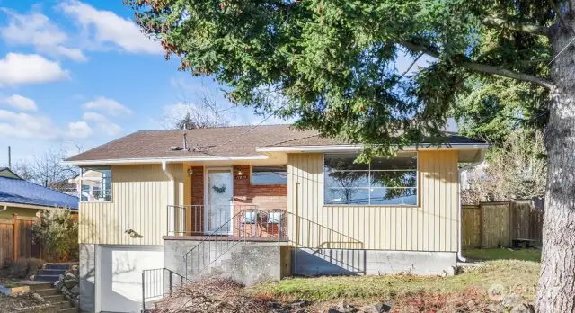 This classic mid-century home (1952) sits high above the street for great privacy, warm sunlight & lovely Seola Greenbelt views. The handsome mantled fireplace creates a focal point for both the living room & dining room. Warm, newly refinished hardwood floors are featured throughout. The kitchen features a corner table nook & plenty of cupboard & counter space to please the chef. The living room features a wall of windows for lovely morning light. Full bath features a tub/shower combination. The west facing, fully fenced, backyard features a large lawn, several garden beds & a sunny patio area. There is garage parking for 1 car & off-street parking pad for two more cars.