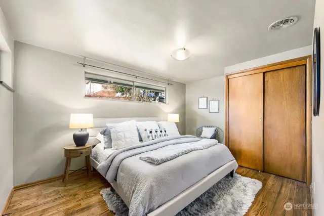 The primary bedroom features room for a king bed, two nightstands and a hi-boy dresser. There is a double closet on this wall and another closet on the opposite wall. There is plenty of room here for your entire wardrobe.