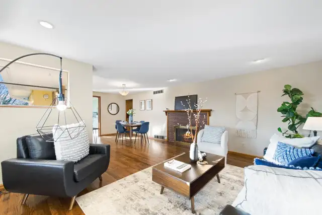 This photos show the large and open space of the combined living and dining room. There is a large south facing corner window for additional light and warmth.