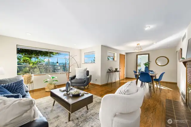 This photo shows the the living room, dining room and the wall of view windows.