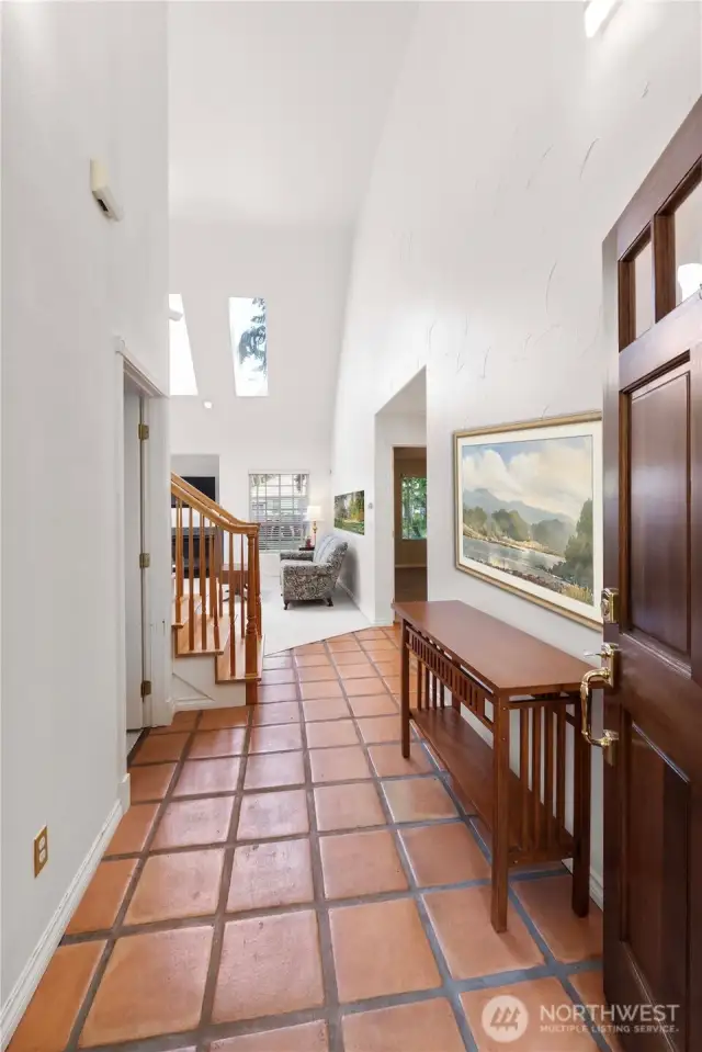 Soaring ceilings and warm terracotta tile floors greet you as you step into this beautifully maintained home, offering a perfect blend of spaciousness and charm.