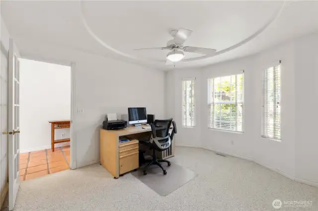 A glass-pane door adds an elegant touch, enhancing the room’s openness while maintaining privacy. Generously sized, the space also includes a closet, providing convenient additional storage.