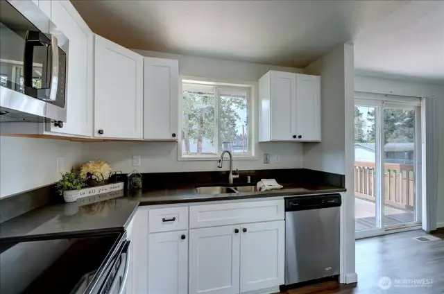Back in from outside, here you can see the newer shaker cabinets and dark gray quartz counters.
