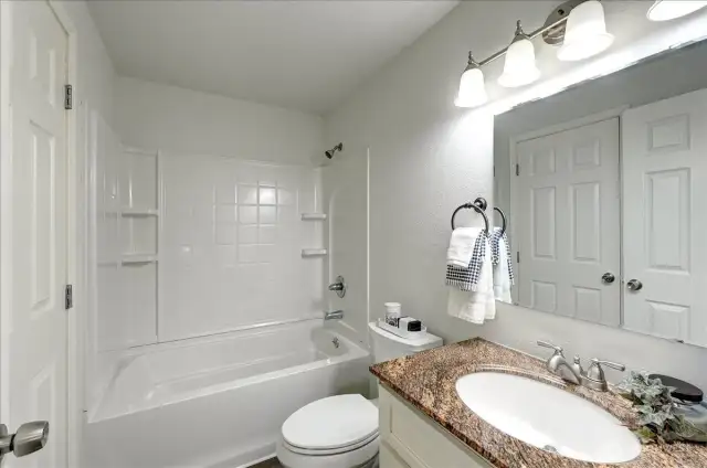Full bath on the main floor. Notice the granite counter and newer vanity in here too.