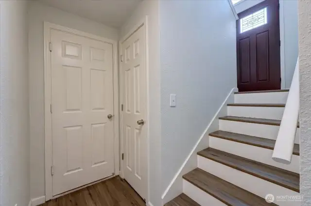At the bottom of the stairs is an "under the stairs" storage closet. Door straight ahead leads to garage.