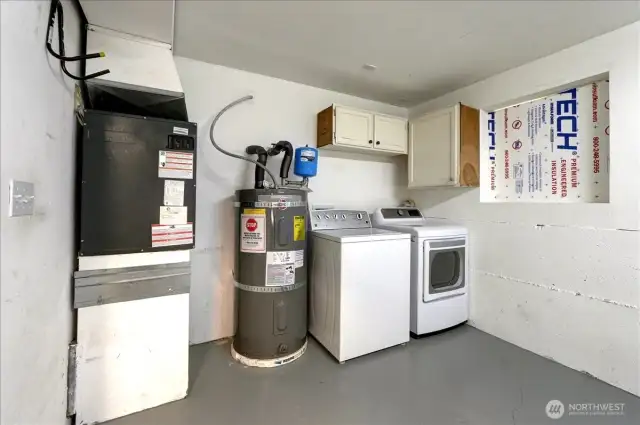 Mechanical corner of garage includes laundry area.