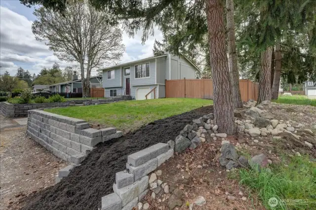 Looking back at your home from the corner of the vacant lot. Grass was recently seeded and barked area is just waiting for your plantings.