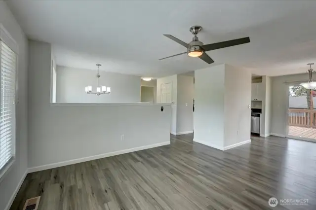 Looking from corner of living room toward entry, dining and kitchen. Notice that all lighting has been updated!