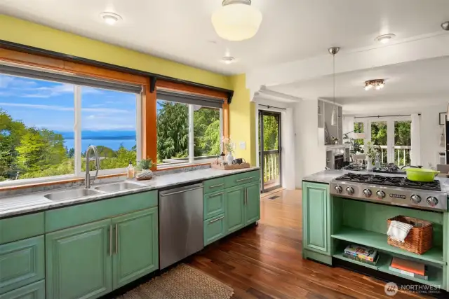 Custom chef's kitchen features marble counters, 6 burner gas range and double oven, and the view!