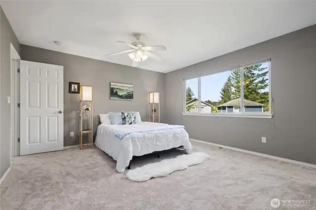 Primary suite upstairs features a walk in closet and bath with walk in shower