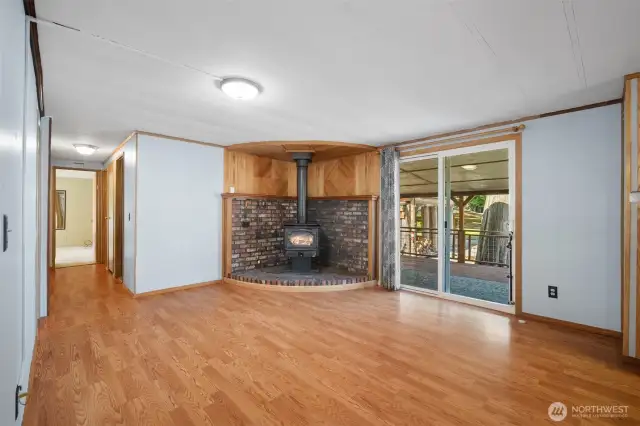 Cozy family room with wood stove and sliding doors leading to the back deck