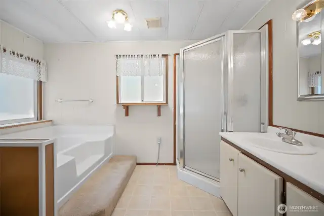 Primary Bathroom features a garden tub and walk in shower.