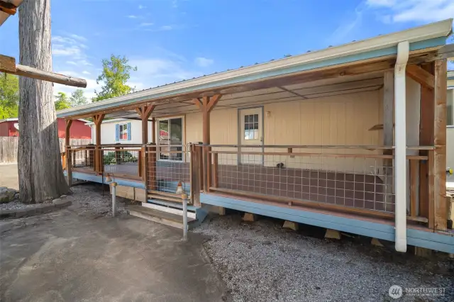 Spacious covered back deck spans the entire length of the home.