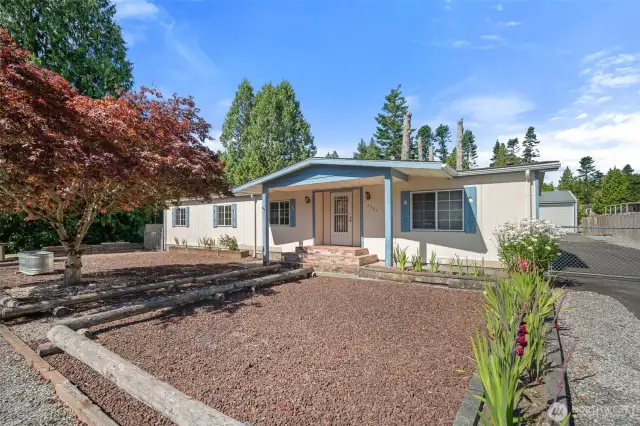 Low-maintenance yard featuring decorative gravel for a clean, tidy appearance.