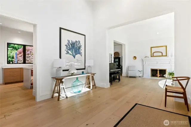 Step into refined elegance with wide-plank hardwood floors, and abundance of natural light. This inviting entry flows seamlessly into a sophisticated living space with a classic fireplace—perfect for both everyday living and entertaining.