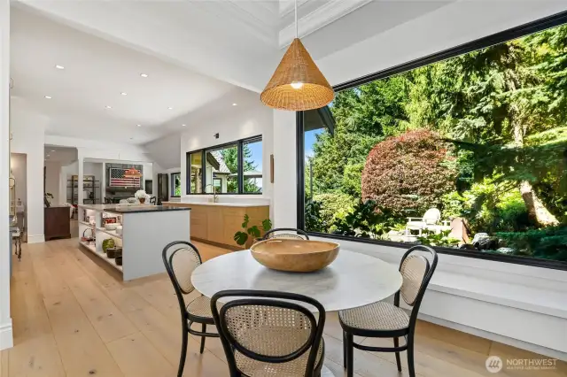 Open-concept kitchen and dining area seamlessly blend modern functionality with natural beauty, ideal for entertaining.