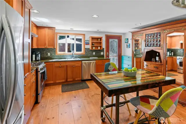 Kitchen features custom cherry cabinets and the beautiful wide plank floors