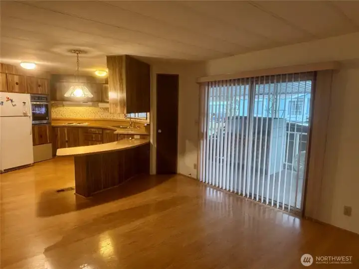 Sliding door entry to the right, dining room looking into kitchen