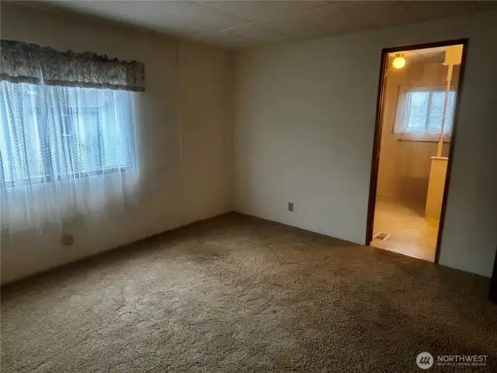 Primary bedroom looking into primary bathroom