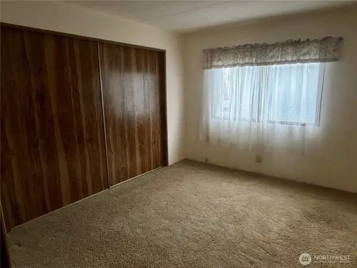 Primary bedroom looking into primary bathroom