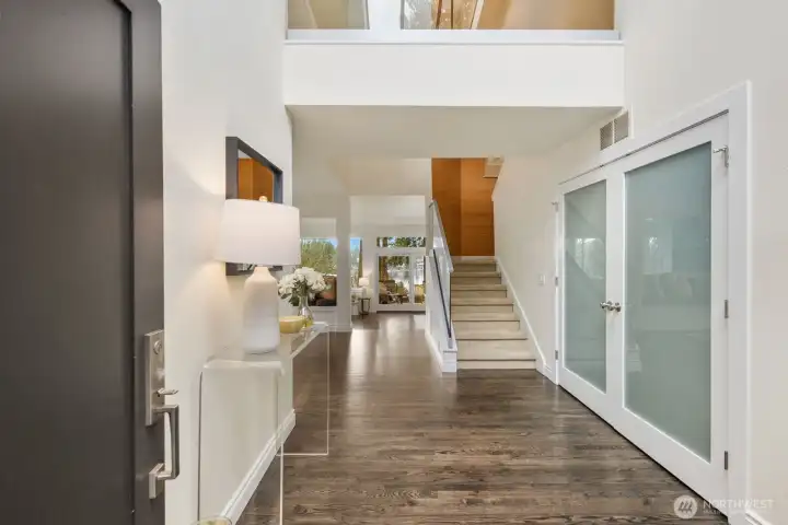 Tall ceilings welcome you to this lovely two-story home with multiple southwest facing windows to Lake Washington and the Olympic Mountains