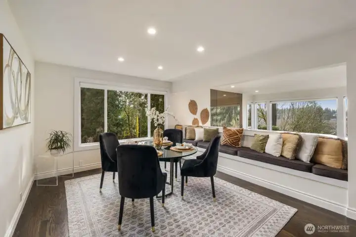 Large, dedicated dining room with cozy seating and extra storage bench