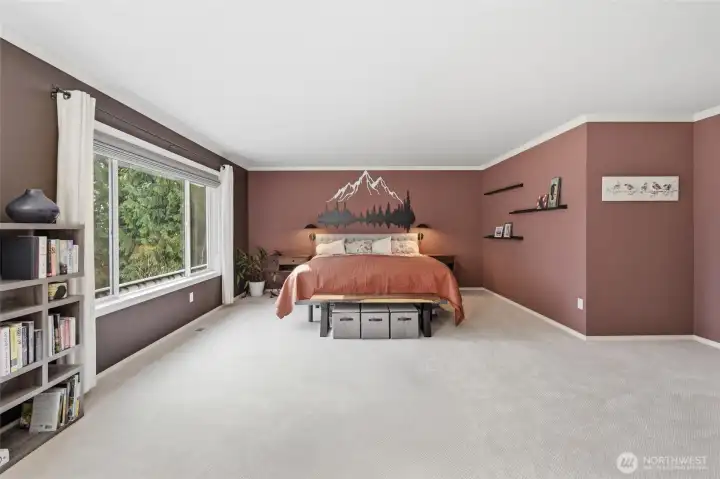 The primary bedroom looks out to the private backyard.