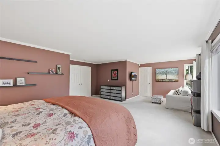 The primary bedroom is expansive with an ensuite sitting area.