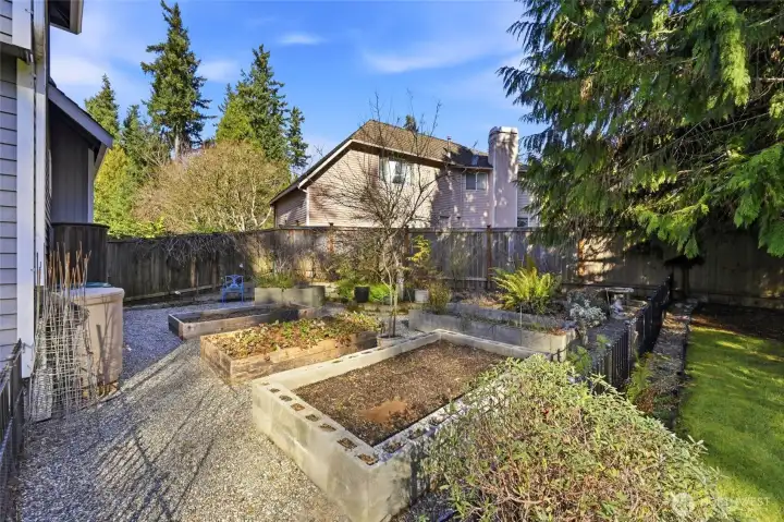 The raised bed garden is fences and has irrigation lines in place, ready for spring planting. Rain barrels are hooked up and ready to water the garden all summer.