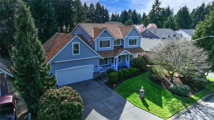 Timeless curb appeal shines with this beautifully maintained 2,438 sq ft home, featuring a classic shake roof, inviting entry, and a warm, welcoming presence.