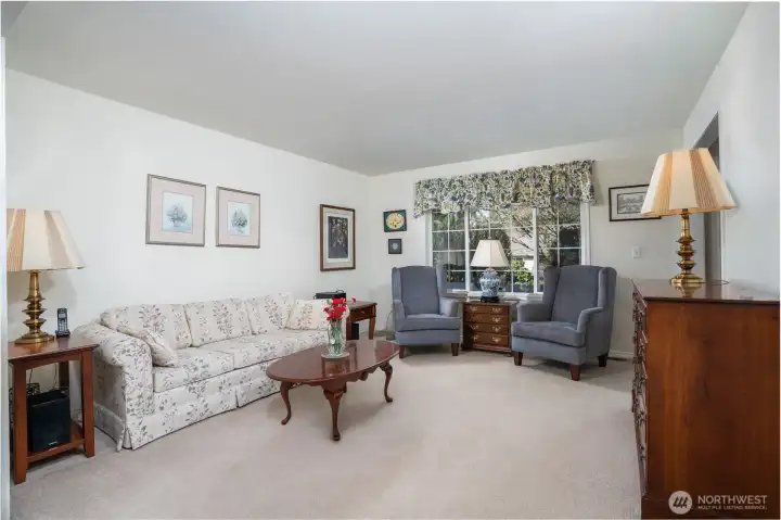 Alternate view of the formal living room highlights its spacious layout and versatile design, perfect for both entertaining and everyday comfort.