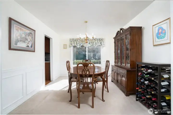 Formal dining room seamlessly connects to the formal living area, with a convenient pocket door leading to the kitchen—perfect for both elegant entertaining and easy flow.