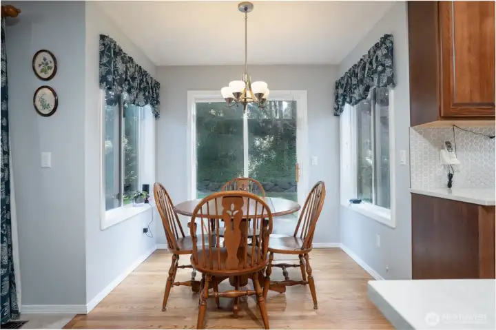 Enjoy meals in the sunny kitchen nook, featuring a convenient door to the backyard for easy indoor-outdoor living.