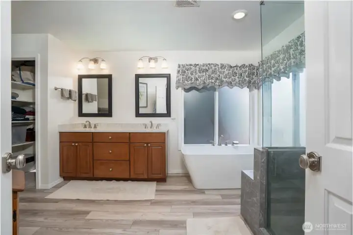 From this angle, the primary bath’s elegant fixtures and thoughtful layout are beautifully showcased.