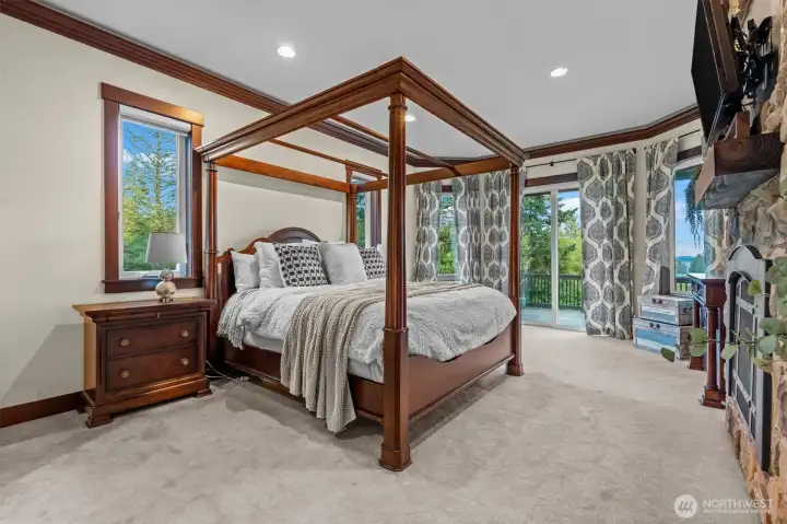 Primary bedroom with deck access and fireplace