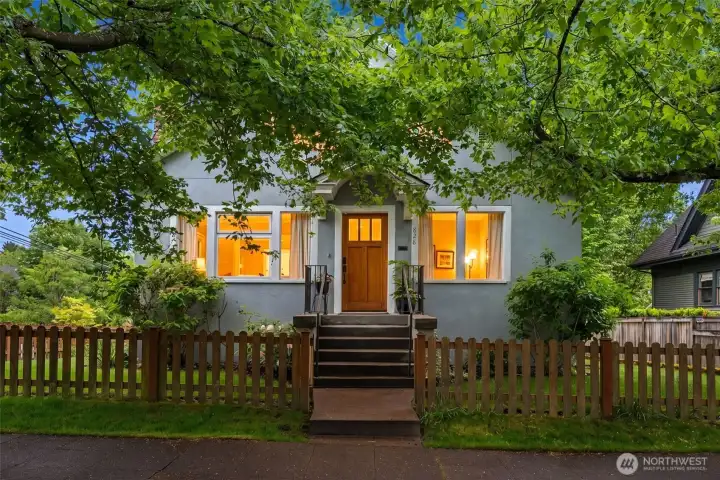 Set on a prime corner lot on a charming street behind a storybook picket fence in the heart of the Central District, this timeless 1925 home blends historic character with everyday functionality